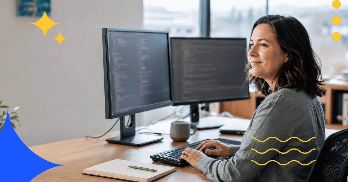 Developer working at a laptop with code displayed on screen